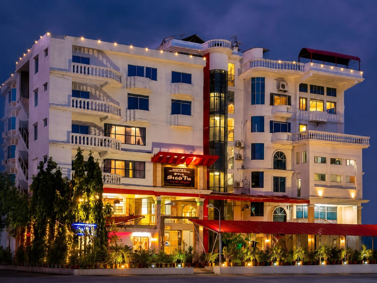 Hotel Siesta building lit up at night in Bogura